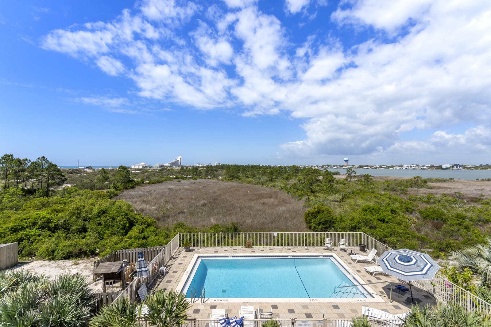 Aerial view over the guest pool, the nature preserve and the water beyond