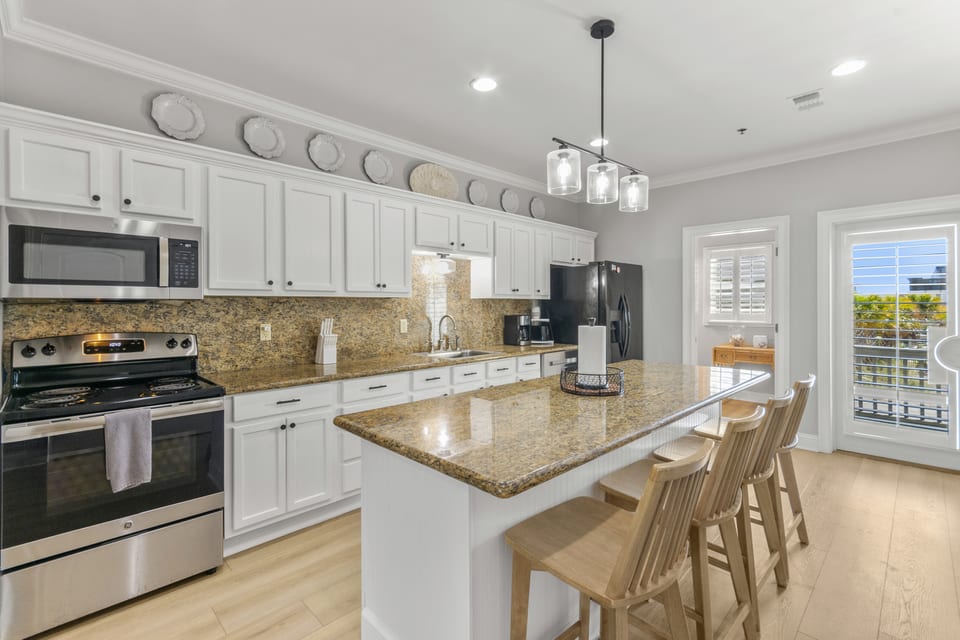 Kitchen with range, stone worktops and white cabinetry