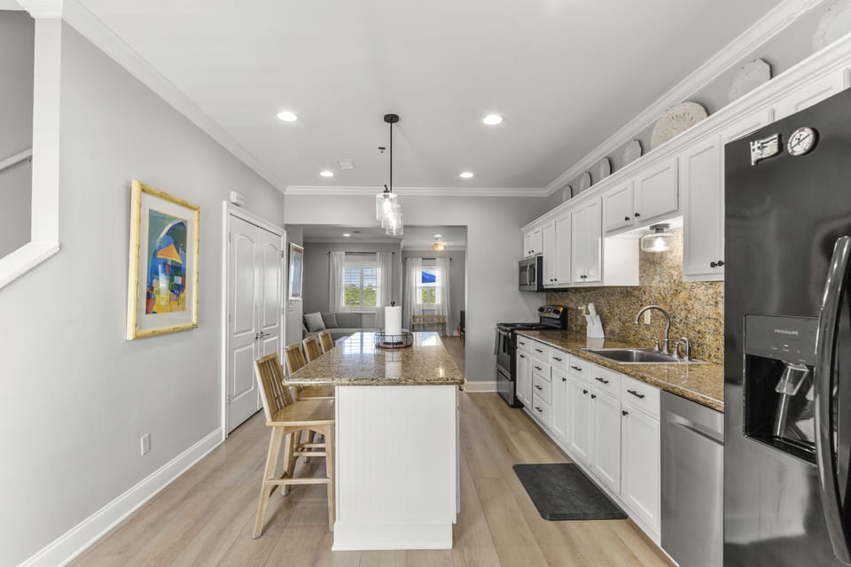 Kitchen from the dining end, with pendant lighting