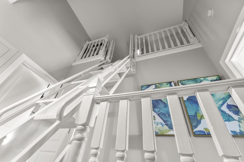 Stairs rising into the sleeping loft