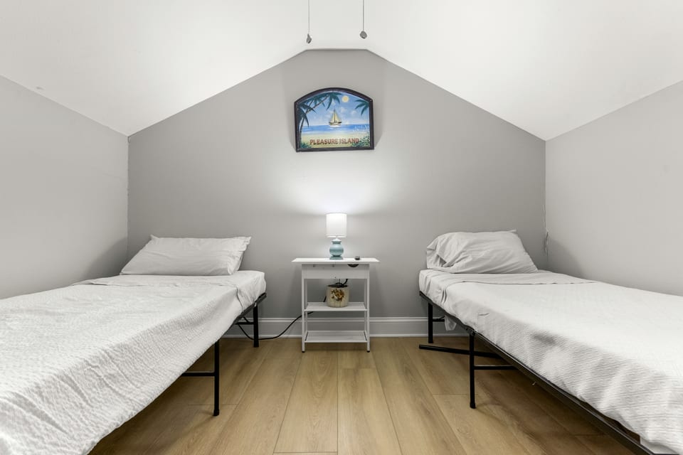 Two twin beds in the loft beneath the eaves