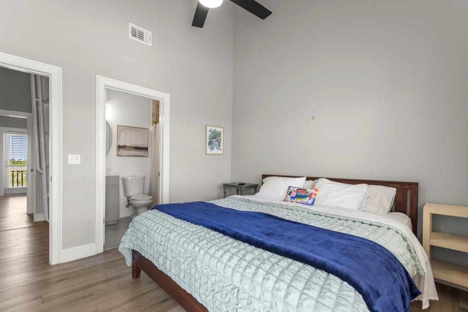 Primary suite with king bed and en-suite beyond